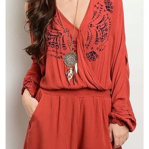 May & July burnt orange and navy Vneck romper w keyhole detail on sleeves. Small